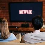 A couple enjoys a relaxed evening watching Netflix in their living room.